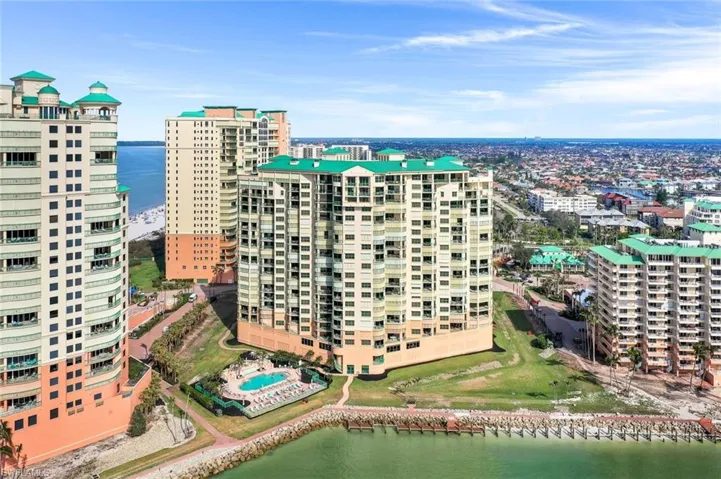 View of urban area with a nearby body of water and apartment complex / building