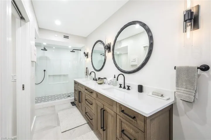 Primary Bathroom featuring double vanity, a stall shower, and recessed lighting