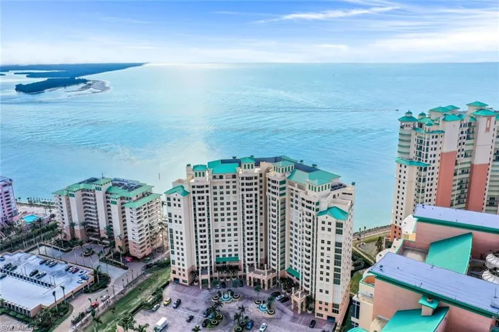 Aerial view of apartment complex / building and a large body of water