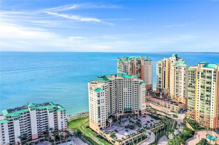 Bird's eye view of apartment complex and a nearby body of water
