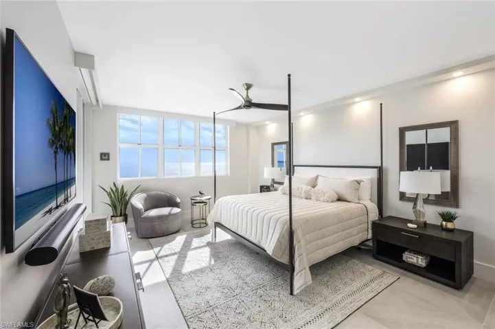 Bedroom featuring a ceiling fan and baseboards