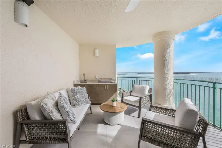 Balcony with outdoor lounge area, a water view, and a sunroom