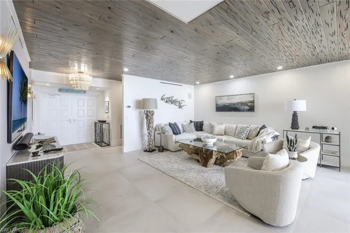 Living area with wooden ceiling and recessed lighting