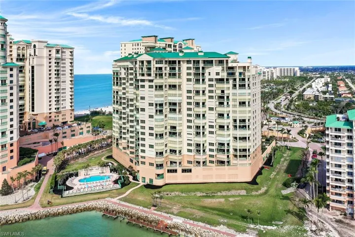 View of apartment building / complex featuring a water view and a city view