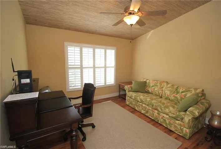 Office area with ceiling fan, hardwood / wood-style floors, and wooden ceiling