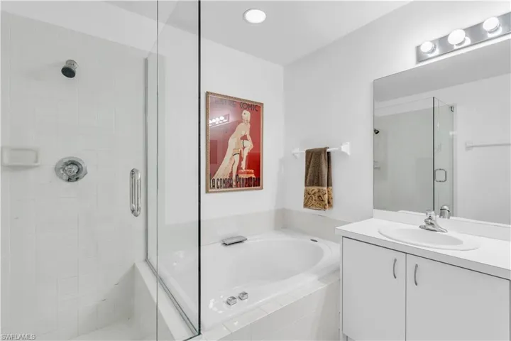Primary Bathroom featuring vanity and plus walk in shower. Needs new tile
