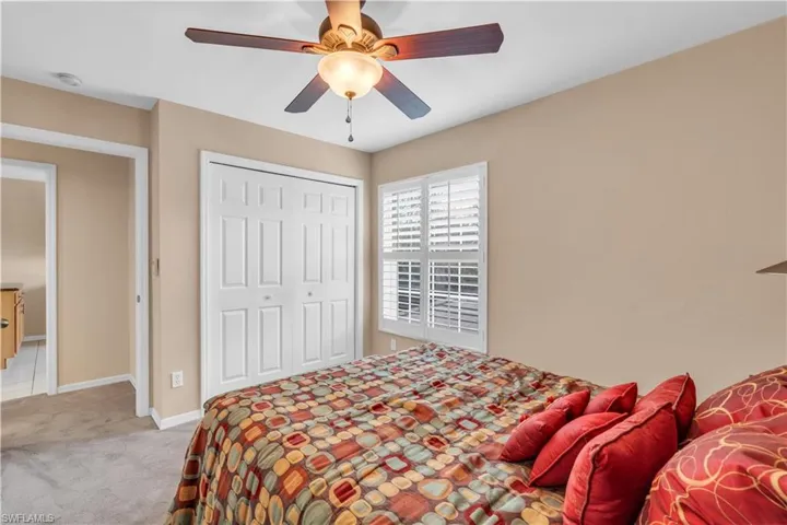 2nd bedroom, Carpeted bedroom featuring a closet and ceiling fan