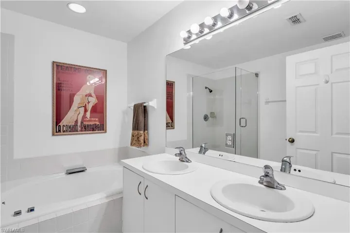Primary Bathroom with vanity and plus walk in shower. Needs new tile