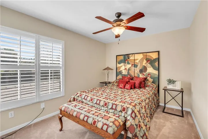 2nd Bedroom with ceiling fan and light colored carpet