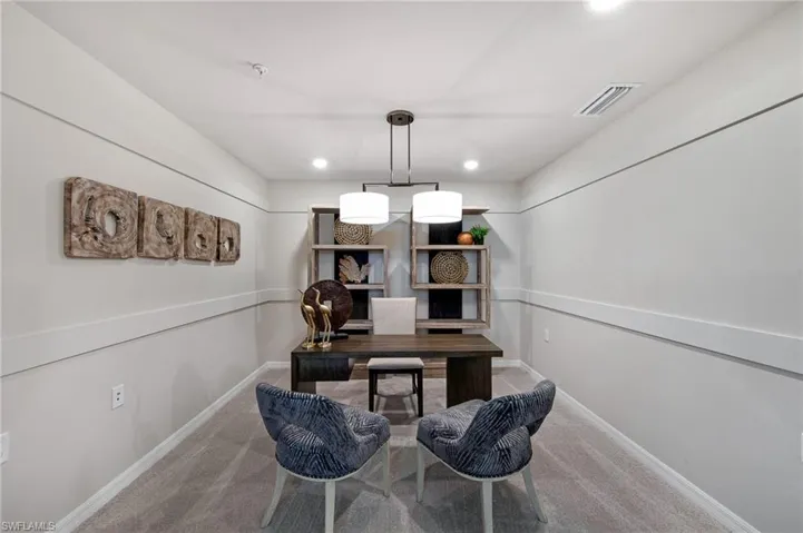 Office with carpet and recessed lighting