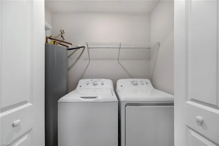 Laundry area with water heater and washer and dryer