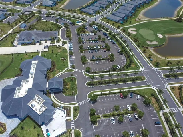 Aerial view of property's location with a nearby body of water and a golf club
