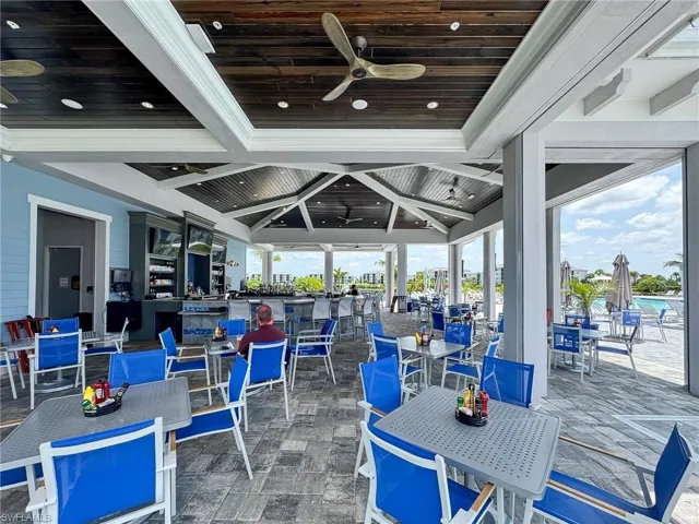 View of patio with ceiling fan and outdoor dining space