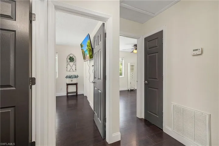 Corridor featuring dark wood-type flooring
