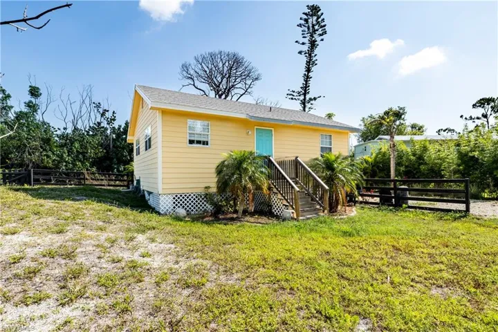 Back of house with a yard