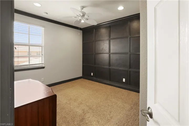 Guest bedroom featuring a ceiling fan, light carpet, crown molding, and recessed lighting