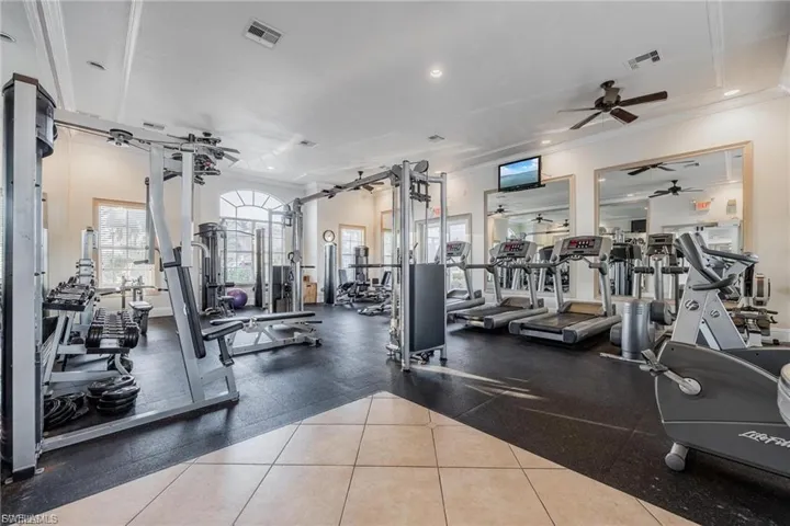 Workout area featuring recessed lighting and ornamental molding