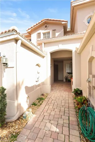 View of exterior entry featuring stucco siding and a tile roof