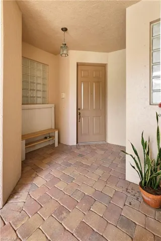 Entrance to property featuring stucco siding