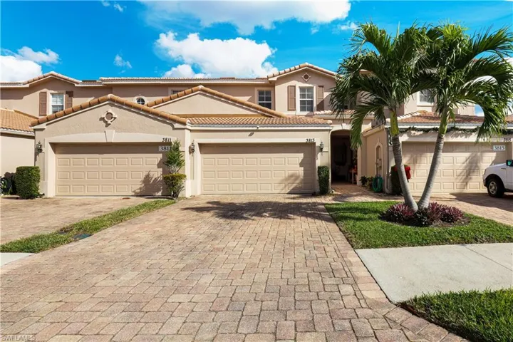 Mediterranean / spanish home featuring stucco siding, decorative driveway, a garage, and a tiled roof