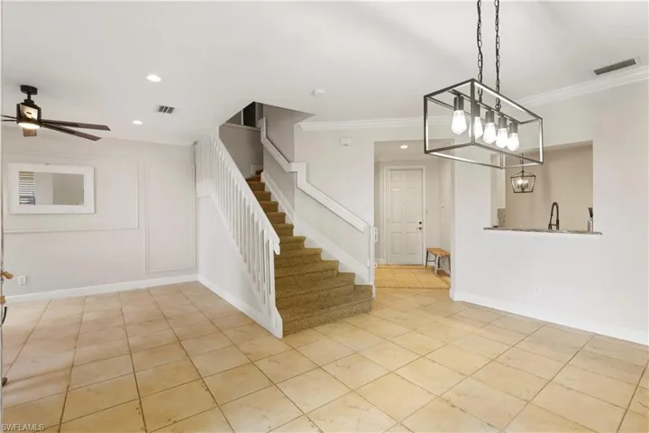Dining area with crown molding, stairs, light tile patterned flooring, a ceiling fan, and recessed lighting