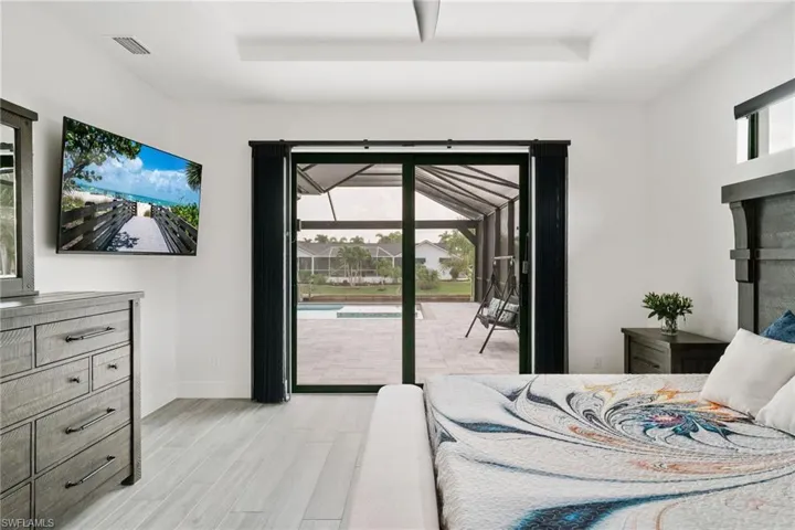 Bedroom featuring a tray ceiling, access to outside