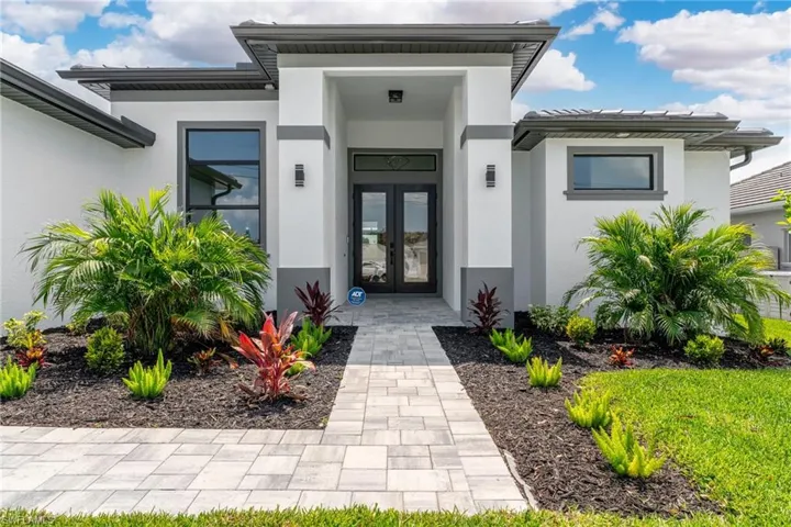 View of exterior entry with french doors and stucco siding