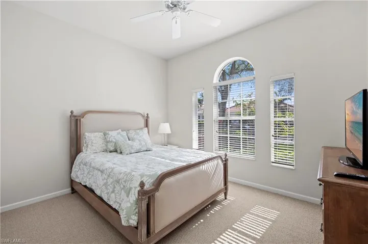 Bedroom featuring a ceiling fan and carpet flooring