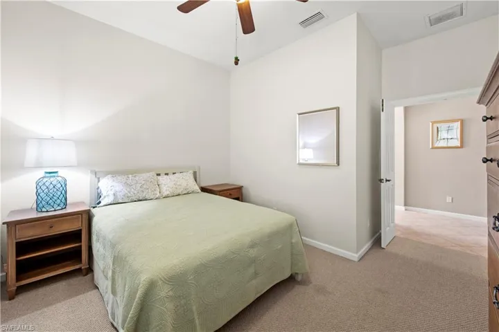 Bedroom with light colored carpet and ceiling fan