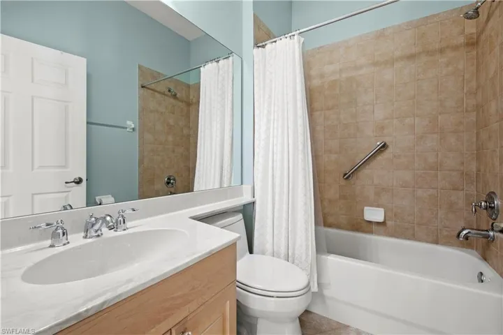 Full bathroom with vanity and shower / bath combination with curtain