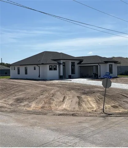 View of front facade with stucco siding and roof with shingles