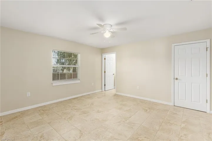 Empty room featuring baseboards and ceiling fan