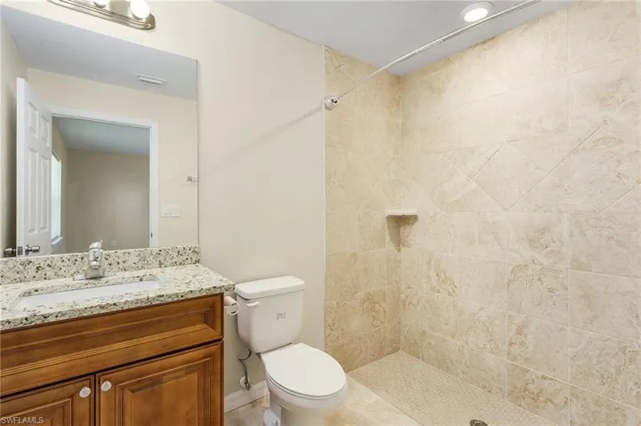 Bathroom featuring a stall shower and vanity