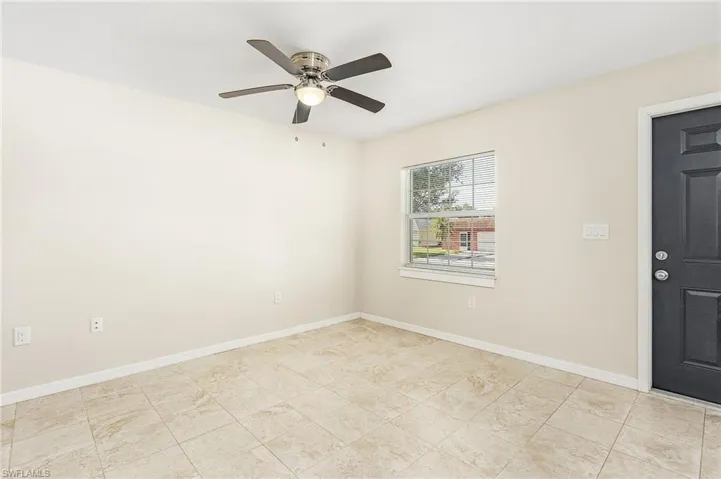 Unfurnished room featuring baseboards and ceiling fan