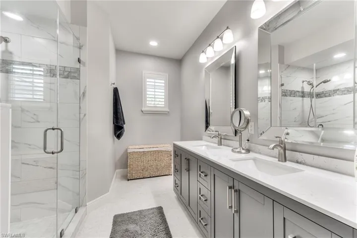 Bathroom featuring walk in shower and vanity