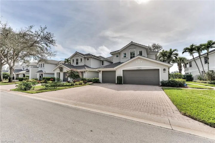 View of front of property featuring a front yard and a garage