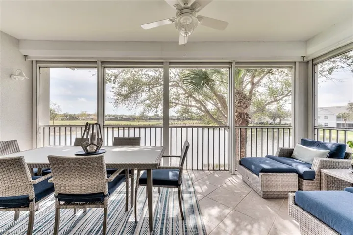 Sunroom / solarium featuring ceiling fan, a water view, and a healthy amount of sunlight