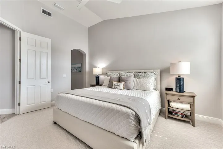 Bedroom featuring carpet floors, lofted ceiling, and ceiling fan