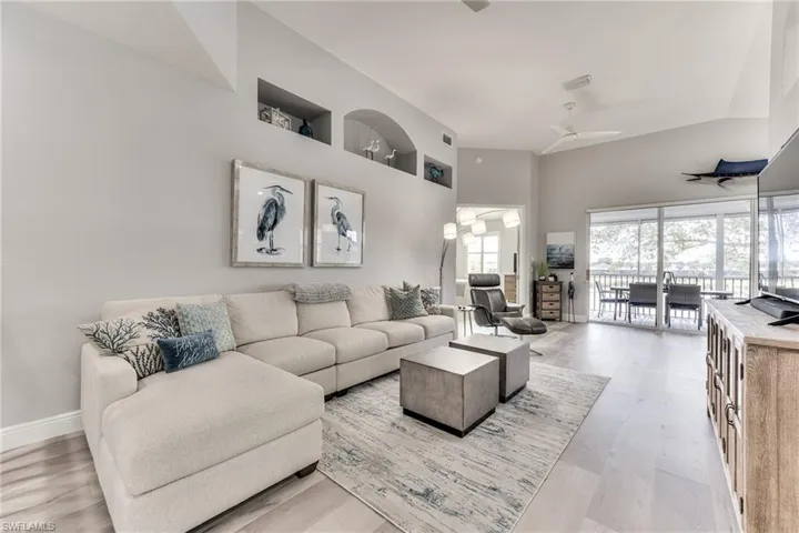 Living room with ceiling fan and light hardwood / wood-style flooring