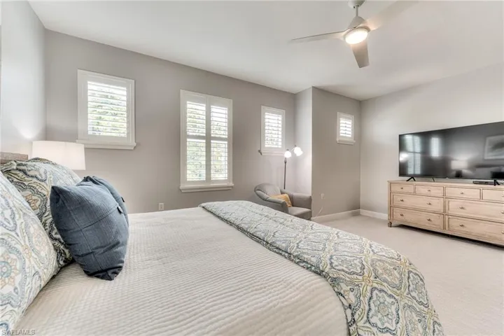 Bedroom featuring ceiling fan and light carpet
