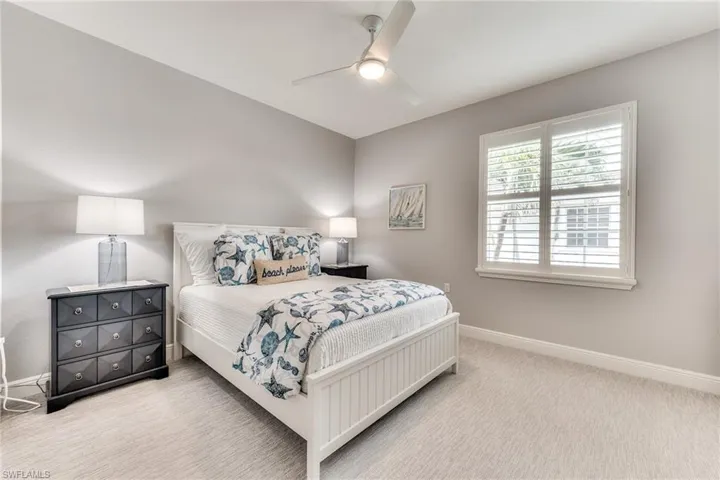 Carpeted bedroom with ceiling fan