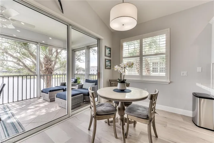 Dining room featuring light hardwood / wood-style flooring and vaulted ceiling