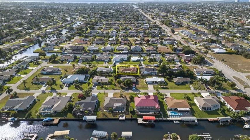 Aerial view of property's location featuring nearby suburban area and a nearby body of water