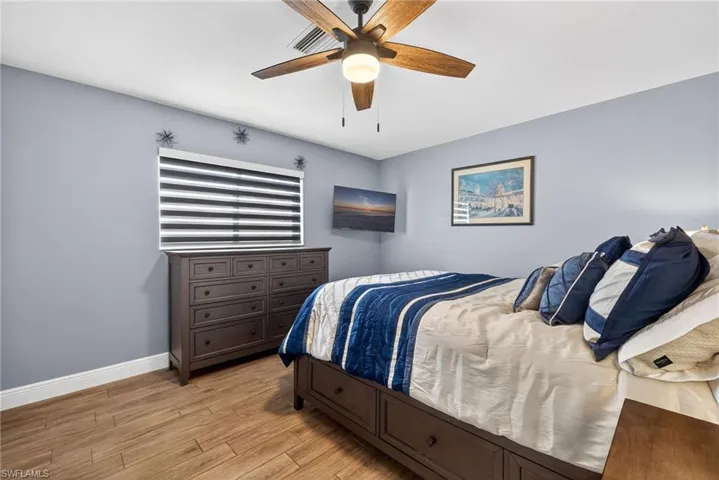 Bedroom with light wood-style floors and a ceiling fan