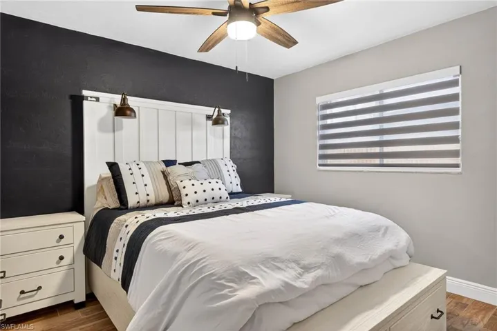 Bedroom with wood finish floors and a ceiling fan