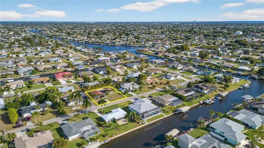 Aerial overview of property's location with nearby suburban area and a large body of water