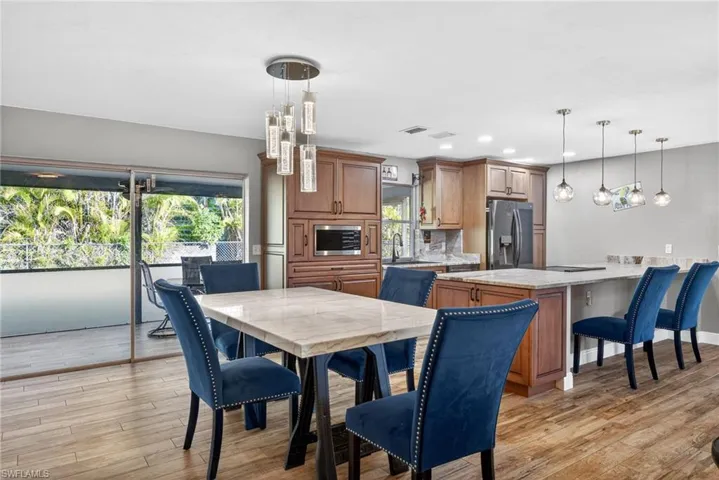 Dining area featuring light wood-style flooring and recessed lighting