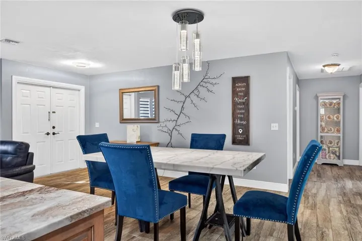Dining area with light wood-type flooring and baseboards
