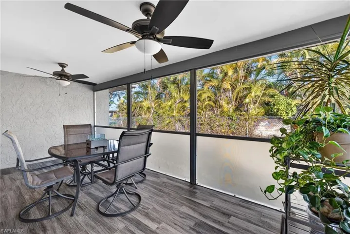 Sunroom featuring outdoor dining area and ceiling fan