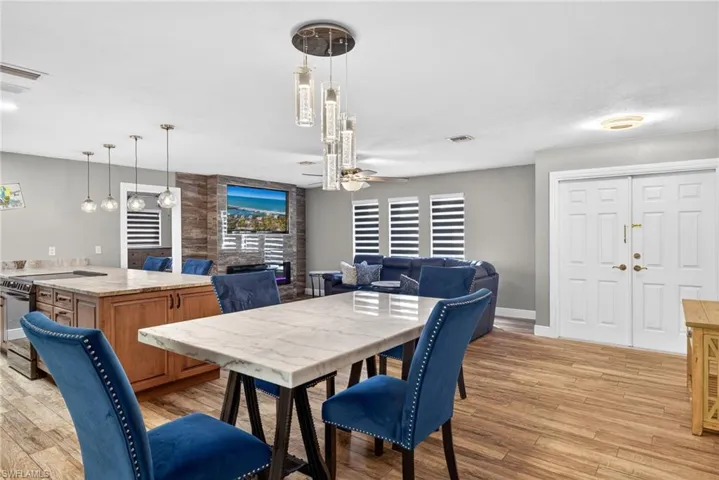 Dining area with light wood finished floors and ceiling fan